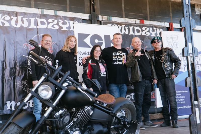 zdjęcie przedstawia sześcioosobową grupę ludzi, na tle motocykla oraz roll-upa powiatu kwidzyńskiego.