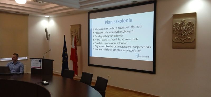 Osoba prowadząca szkolenie przy stole konferencyjnym prezentująca program szkolenia dla drugiej grupy szkoleniowej